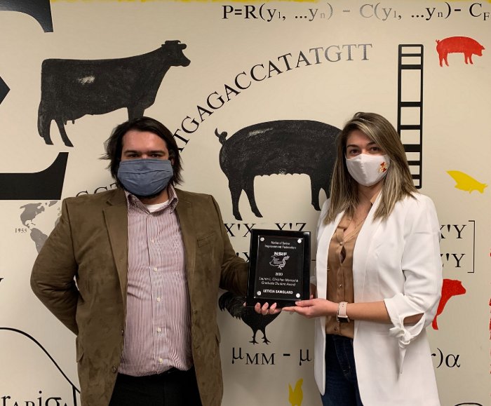 Nick Serão (left), assistant professor of animal science at Iowa State University, presenting the 2020 National Swine Improvement Federation (NSIF) Graduate Student Award to Leticia Sanglard, Iowa State animal science doctoral candidate. Sanglard gave a talk at the national virtual event, 3 December, based on research she has been involved with in Serão’s lab.